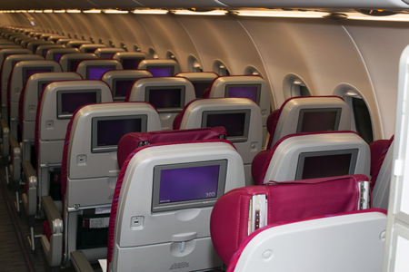 Borispol, Ukraine - August 28, 2017: Qatar Airways Airbus A320 economy class seats with entertainment system onboard. Editorial use onlyのeditorial素材