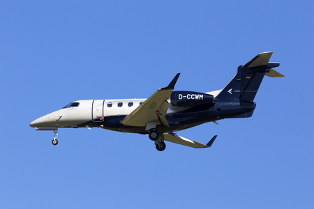 Borispol, Ukraine - May 26, 2018: D-CCWM MHS Aviation Embraer EMB-505 Phenom 300 aircraft on the blue sky backgroundのeditorial素材