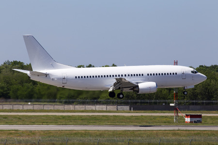 Big modern white aircraft landing on the runwayのeditorial素材