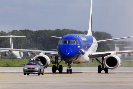 Borispol, Ukraine - August 01, 2018: Meeting of the first flight to Ukraine of ER-ECB Air Moldova Embraer ERJ-190 with water rainbow at Borispol International Airportのeditorial素材