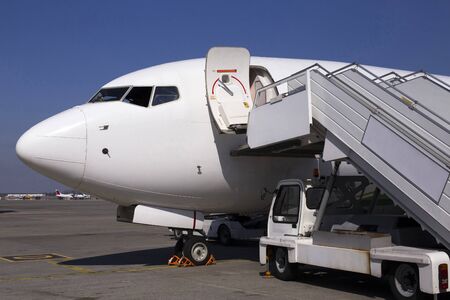 White modern aircraft on the parking zone awaiting service maintenanceの写真素材