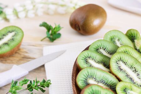 juicy kiwi slices on a wooden plateの写真素材