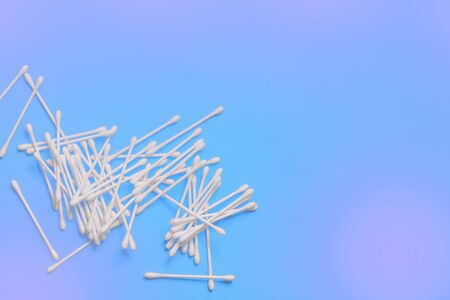 Ear sticks on blue purple background. Makeup removal and skin care concept. Space for textdesign