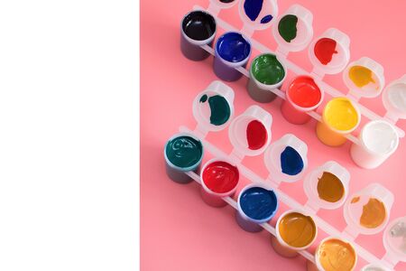 Multi-colored paint in cans on pink background. Palette of colors. Concept - creativity and school theme.の写真素材