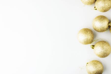 Golden christmas balls on grey background with sequins. Christmas composition. Christmas holiday celebration concept, Merry Christmas and Winter holidays. Flat lay, top view, copy space for text