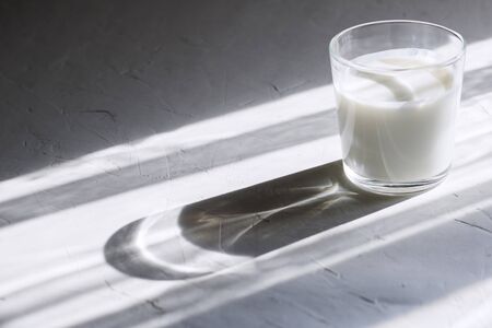 Organic probiotic milk kefir drink or yogurt in glass containers,on the white grey background. Gut...