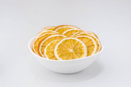 Eco organic homemade dried orange slices, chips. Dehydrated crispy fruit slices. Heap, pile of sun dried crunchy oranges. Healthy snack. Close up. Top view. Copy spaceの写真素材