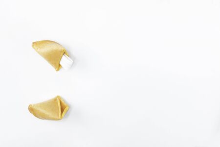 Fortune cookie. Broken fortune cookies with blank slip isolated on white background. Fortune cookie. The concept of magic rituals, fortune telling. Copy spaceの写真素材