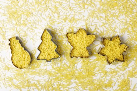 Creative christmas shapes shapes with pasta inside, on white background. Creative christmas cuisine...
