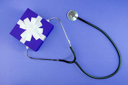 Gift with a phonendoscope. Medicine gift concept.の写真素材