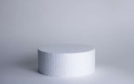 Geometric shape cylinder on white gray background. Drawing a light shadow. Copy spaceの写真素材