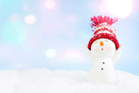 Happy snowman standing in winter christmas landscape. Christmas background. Merry christmas and...