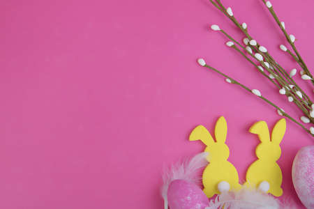 Easter background. Silhouette of rabbits, Easter eggs and pussy willow on a pink background. Copy space.の写真素材