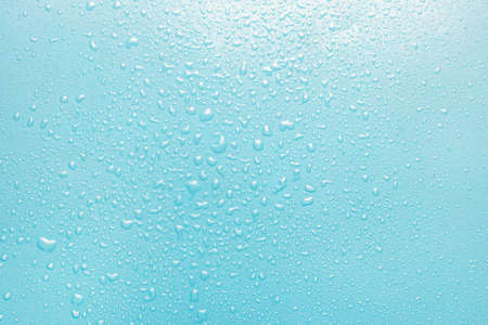 Water drops on a green, blue background. Texture top view