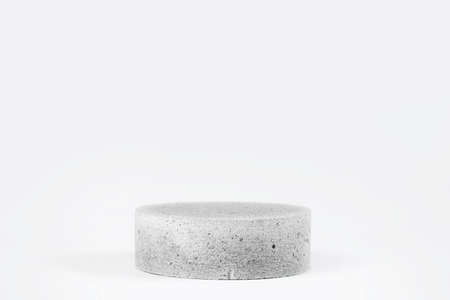 Cylinder shaped concrete podium isolated on white background.