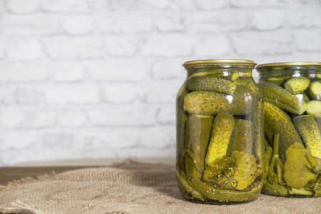 Homemade canned food. Pickled snacks for the winter. Pickled cucumbers with herbs and spices in...