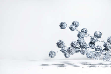 Creative layout of Christmas geometric decorations with balls Christmas tree on a white background in the rays of the sun with shadows. Minimal winter festive christmas new year exotic concept with copy space. Christmas bannerの写真素材