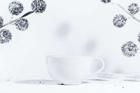 Christmas background with a white ceramic mug with a winter drink, on a white background with...