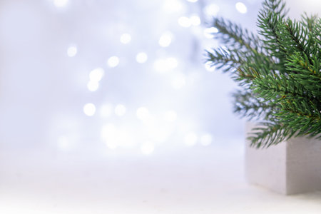 Christmas background with Christmas tree and Christmas lights from garland. Selective focus. White blue Christmas background.の写真素材