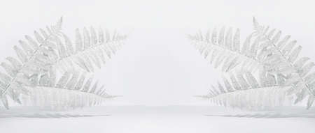 Creative layout of white snow-covered leaves with crystals of snowflakes on a white background in the rays of the sun with shadows. Minimal christmas, winter or new year concept with copy space. Bannerの写真素材