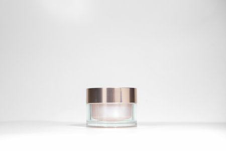 A mock up jar of cream isolated on a white gray background, on a white table with hard shadows. Stylish look of the product, identity.の写真素材