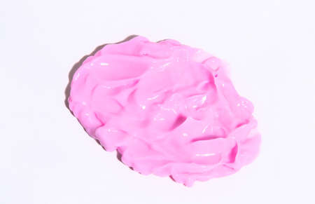 Swabs of creamy textures pink color. Smear of skincare cosmetics product pink color. Strokes of makeup cream, moisturizing body lotion or hand cream. Cosmetology wellness and beauty concept. In the sun, hard shadowsの写真素材