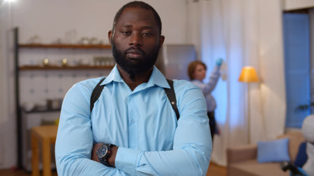 Portrait of African-American detective in suspenders posing at camera investigating murderの写真素材