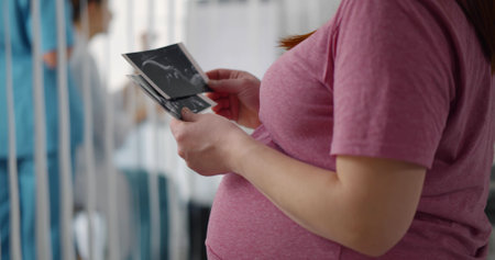 Cropped shot of pregnant woman holding sonogram pictureの写真素材