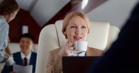 Stewardess serving order for passenger in business classの写真素材