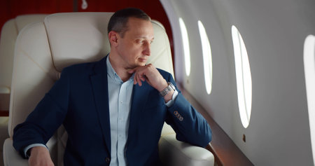 Businessman in suit on business trip by first class flight.の写真素材