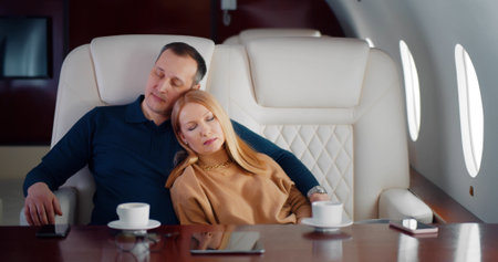 Portrait of mature couple sleeping in luxurious private jetの写真素材