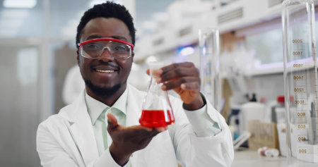 African scientist with flask working on antiviral treatment development.の写真素材