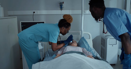 African-American medical workers checking eyes of dead patientの写真素材