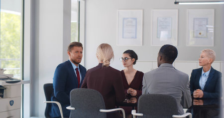 Corporate business team sitting at table in meeting