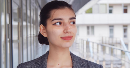 Close up portrait of attractive young secretary posing outside business centerの写真素材