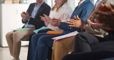 Cropped shot of diverse people sitting in row at business conference and applaudingの写真素材