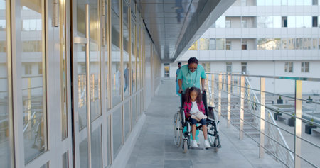 Medical staff and patient outside hospital buildingの写真素材