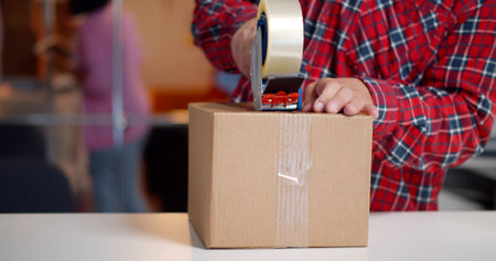 Cropped shot of online seller work at office and pack shipping delivery box to customer.の写真素材
