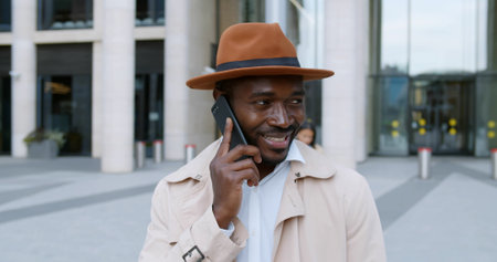 Young handsome businessman talking on cellphone outdoors