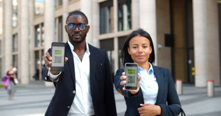 colleagues showing smartphone with virtual immunity passport smiling at camera