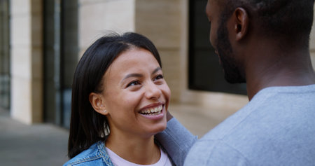 Happy mixed race couple together outdoors in city.の写真素材