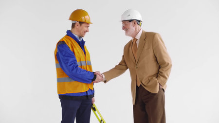 Engineer and architect handshake isolated on white backgroundの写真素材