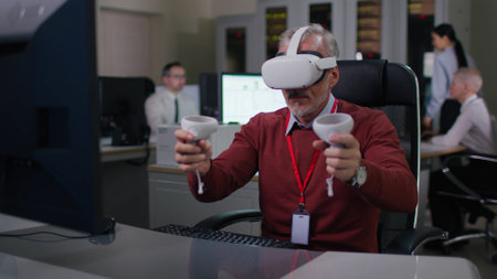 Mature it programmer put on vr goggles and take controllers working at desk on computer