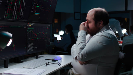 Side view of sad fat broker look at monitors and cry loosing investments money on stock marketの写真素材