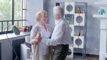 Senior couple relaxing at home, dancing.の写真素材