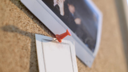 Closeup of cork board with notes and photosの写真素材
