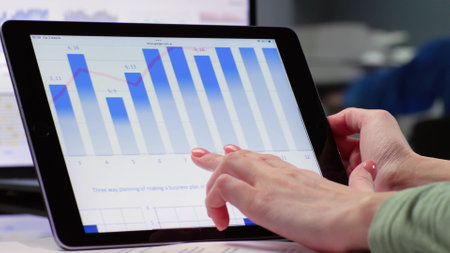 Close up of female hand scroll tablet screen with diagramの写真素材