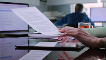 Cropped shot of female clerk read contract and scroll digital tablet at workplaceの写真素材