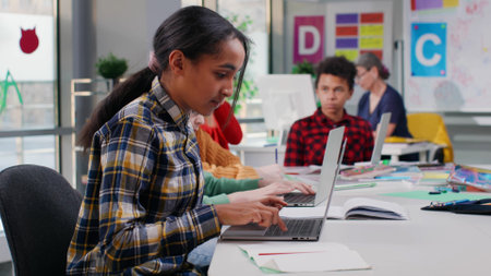 Multiethnic teen kids study on laptop in computer classの写真素材