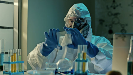 Doctor in ppe suit and respiratory mask conducting scientific virus research holding test glass